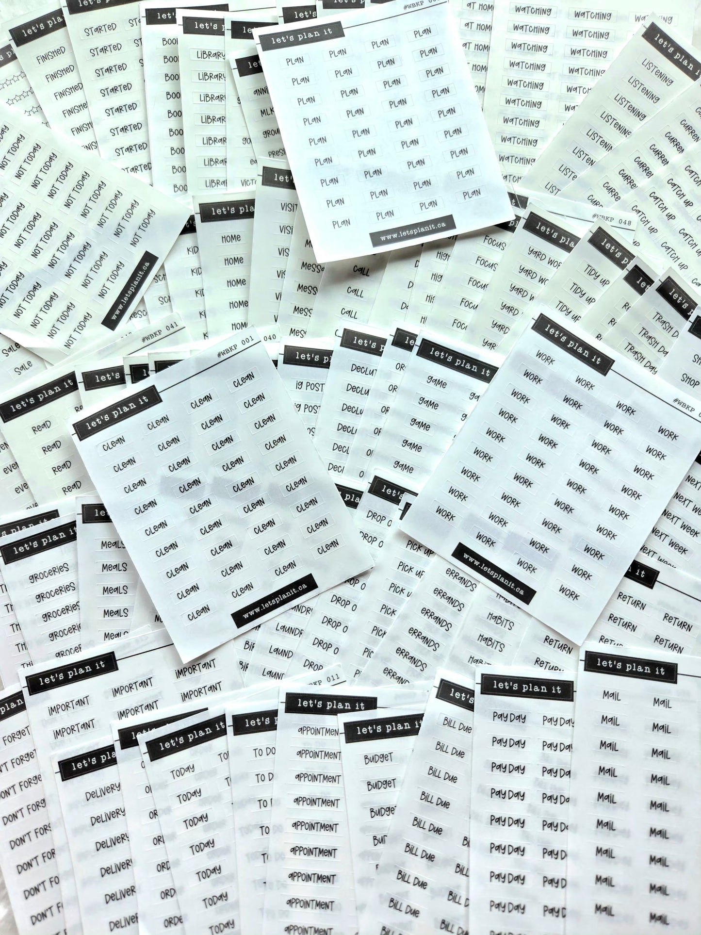 Multiple sheets of planner stickers with text on a white background